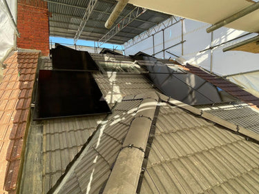 Rooftop solar panels installation under scaffolding